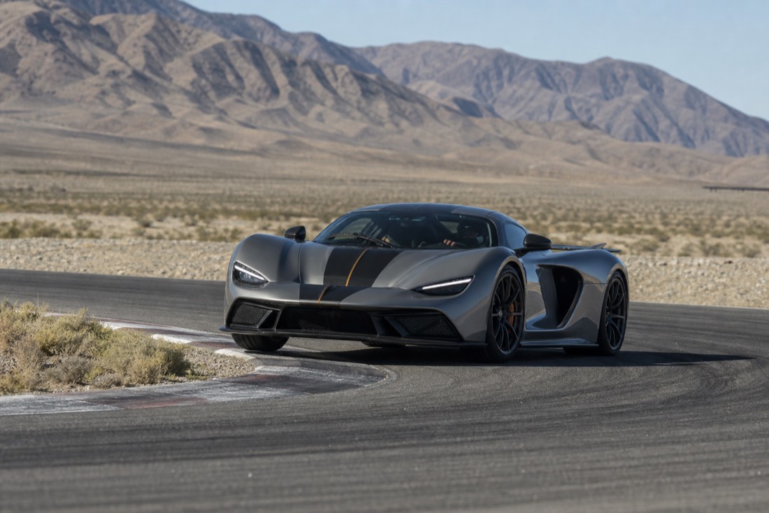 A supercar hitting the apex of a corner on a desert track